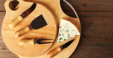 blue cheese and knives on kitchen boards